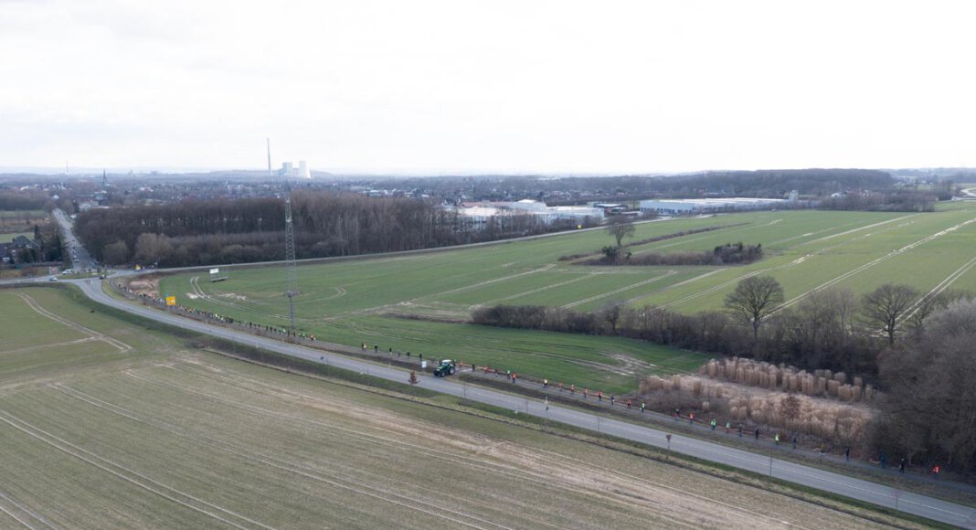 Im Vordergrund ist ein Teil der landwirtschaftlichen Fläche zu sehen, die zu einem Industriegebiet entwickelt werden soll. Foto: Kreativshooting/T. Schütte