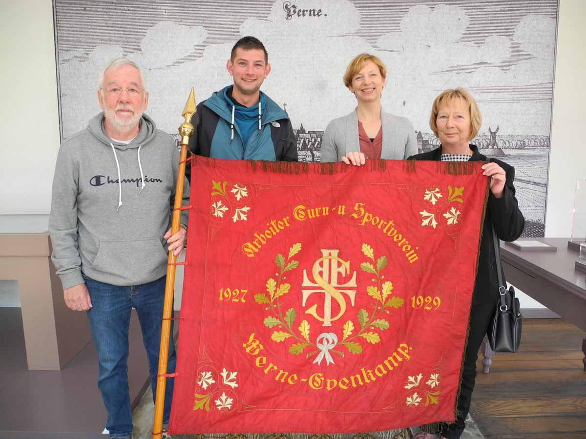 Heinz Meinke, Robin Böcker (v.li.) und Iris Kalinowski (re.) vom Eintracht-Vorstand übergaben die historische Fahne des VfL Werne an Museumsleiterin Dr. Constanze Döhrer. Sie findet einen Platz in der neuen Dauerausstellung des Stadtmuseums. Foto: Klaus Brüggemann