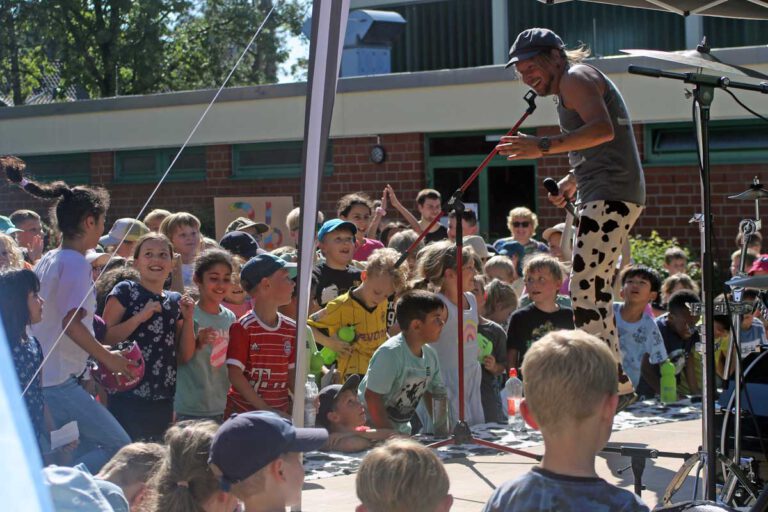 Kindermusiker Maxim Wartenberg sorgte als "Trommelfloh" für viele glückliche Kindergesichter auf dem Hof der Wiehagenschule. Fotos: Wagner